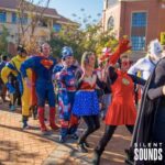 SILENT WALKING TOUR HIRE (1) A group of people in costumes are having a parade outside wearing Silent Sounds Headphones.