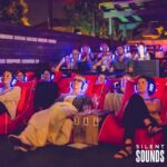 SILENT CINEMA HIRE (2) A group of people sitting down watching a movie wearing Silent Sounds Headphones