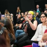 SILENT CONFERENCE HIRE (2) A person in the audience asking a question wearing Silent Sounds Headphones and using a Silent Sounds microphone