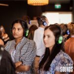 SILENT CONFERENCE HIRE (4) Two females wearing Silent Sounds Headphones at a conference event.