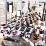 SILENT YOGA & FITNESS HIRE (4) Yoga event with a group of people wearing Silent Sounds Headphones inside a shopping centre