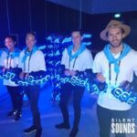 STAFFED EVENTS HIRE (1) Happy Staff (headphone hosts) are handing out Silent Sounds Headphones at an event.