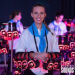 STAFFED EVENTS HIRE (2) A happy headphone host handing out Silent Sounds Headphones at an event.